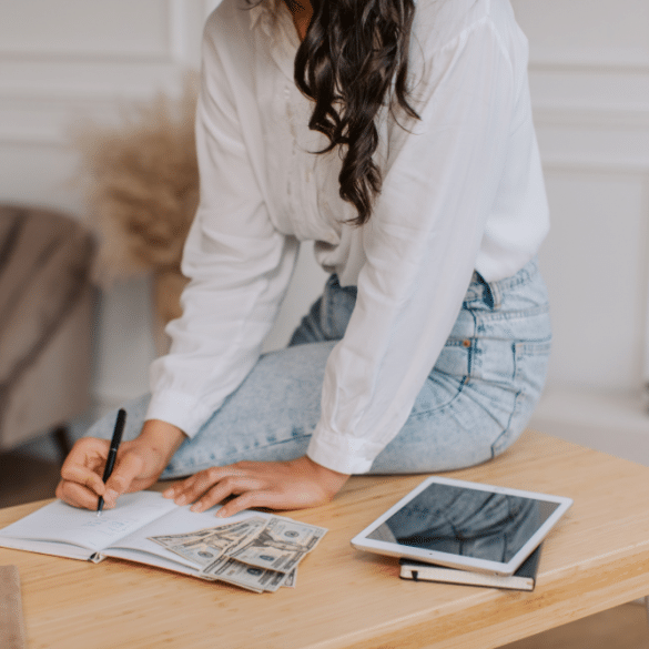 Woman calculating fees on a desk