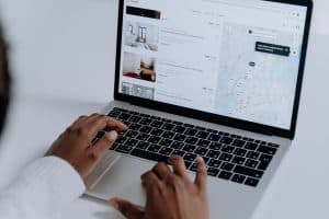 Someone navigating the Airbnb site on a laptop