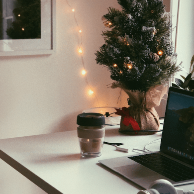 Laptop and small Christmas tree on a desk