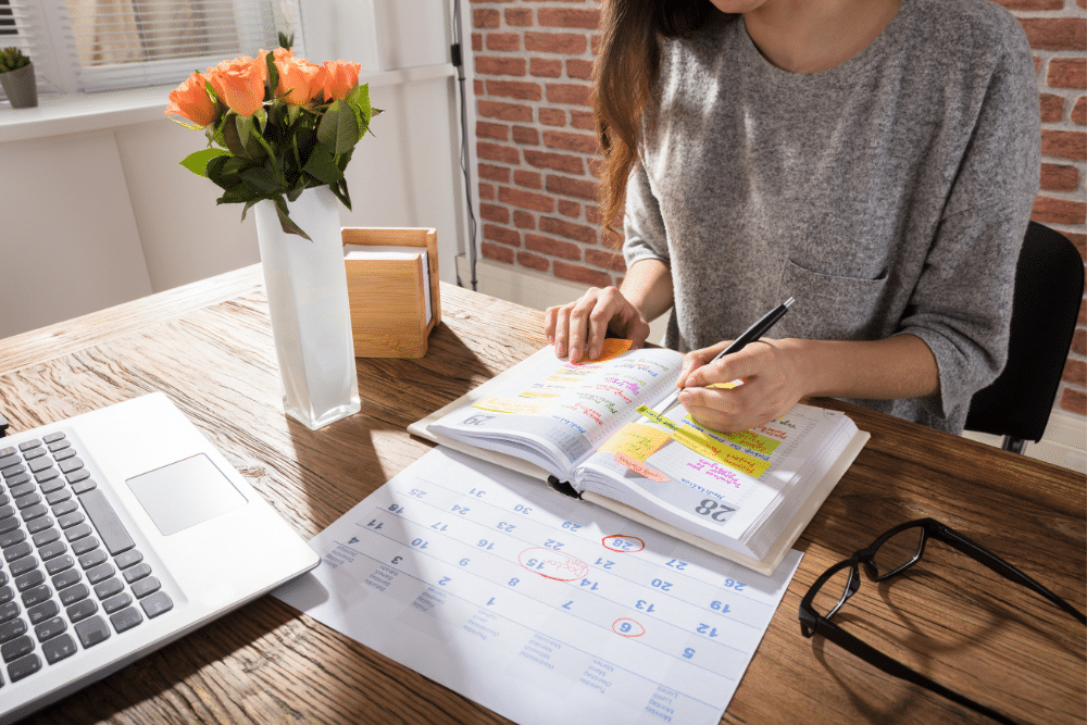 Woman writing in calendar book