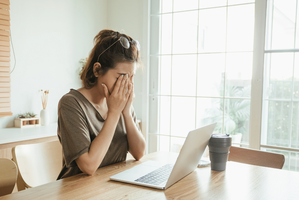 Frustrated woman at laptop