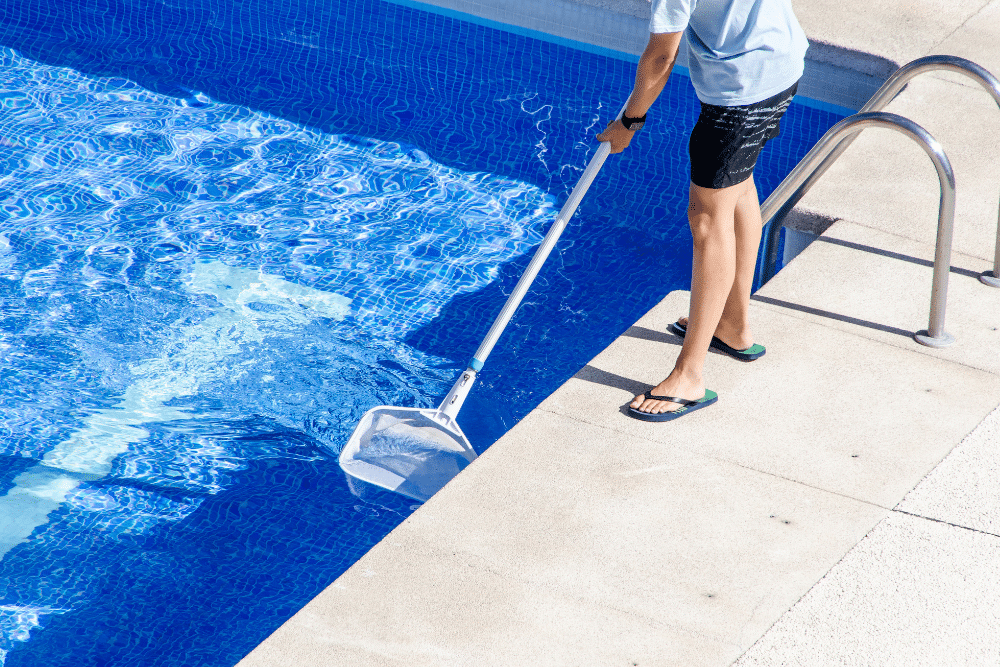 Person cleaning pool